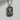 Oxidized 925 sterling silver St. Jude pendant hanging from a rolo chain, shown against a textured white concrete wall.