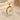 Elegant gold vermeil style heart pendant featuring sparkling cubic zirconia curved accents on beige silk