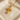 Gold variant of the ornate cross pendant displaying diamond settings and scalloped design