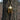 Gold tone Spartan helmet pendant with American flag stars and stripes detail in forest setting