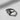 Close-up of oxidized silver whale tail ring highlighting the detailed texture, dark finish, and embedded gemstone