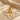 Gold vermeil variant of Egyptian Horus pendant necklace displayed on elegant beige satin fabric
