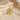 Gold variation of tree of life pendant necklace displayed on beige satin background