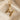 Close-up of the 925 sterling silver bird letter H pendant with gold vermeil resting beautifully on smooth silk fabric