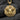 Detailed octagonal medusa pendant necklace resting on rough dark charcoal stones to highlight the striking metalwork