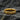 Angled view of the textured geometric band ring resting on a dark stone background highlighting the rich pattern.
