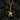 Close-up of skeleton guitar pendant resting on dark coals highlighting intricate bone and skull details