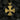 Close-up of the detailed 3D skull and carved fire motifs on the gothic cross pendant resting against dark coal