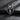 Oxidized 925 sterling silver dog pendant nestled in angel wings on slate
