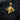 Gold vermeil ram pendant with intricate wool texture and large spiral horns displayed on a textured black wood stump