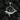 Oxidized 925 sterling silver whale necklace with black spinel stones in a spiral wave design
