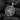 Angled view of handcrafted silver griffin medallion showing oxidized relief details