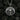 Front view of 925 sterling silver skull pendant with wings biker style jewelry centered on charcoal