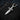 Oxidized dark silver celtic dagger pendant showing detailed knotwork and pointed blade design in moody lighting