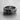 Angled view of the textured silver cross ring, highlighting the rough band, central emblem, and polished inner shank.