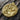 Freyja Goddess Lynx Pendant, gold vermeil, angled close-up on bark