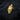 Tilted Crown Skull Pendant, gold vermeil, angled front view on textured wood