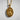 Close-up of Saint Gabriel oval medal showing intricate angel wings and lily details carved in precious metal