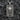 Angled view of rectangular silver dog tag pendant featuring high relief skull figure and gothic text inscription