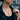 Woman wearing the rose gold plated oxidized silver caduceus pendant necklace with a casual denim jacket.