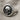Round Skull Signet Ring, oxidized silver, angled side view on fabric