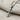 Gemstone Cross Pendant, oxidized silver, angled close-up on fabric