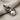 Bow Tie Cat Pendant, oxidized, angled view on linen