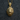 Close-up of roaring lion pendant with ornate fleur-de-lis bail resting elegantly on a dark textured background.