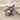 Crawling Spider Pendant, oxidized, angled view on sand