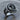 Close-up of sculptural abstract swirl ring resting on a wooden surface, highlighting intricate silver metalwork