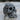 Close-up of handcrafted floral skull ring showing detailed metalwork and oxidized silver contrast resting on wood surface