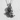 Handcrafted cherub angel pendant in oxidized silver resting on a textured white surface casting a soft shadow