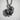 Close-up of handcrafted Pomeranian Spitz pendant showing detailed silver craftsmanship on a textured surface
