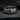 Close-up of the vintage Stonewall 1969 ring resting on dark textured stone showing deep engraving and antique patina.