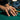 Lifestyle shot of oxidized silver kissing men ring worn on a man's hand resting on a green billiard pool table