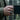 Lifestyle shot of oxidized silver Masonic signet ring worn on a man's hand holding a mug in a natural forest setting