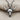Close-up of the oxidized silver buffalo skull pendant resting on textured fabric highlighting dark eye sockets