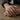 Man wearing the masculine Good signet ring on his finger resting on a rustic wooden table surface