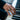 Lifestyle shot of the oxidized silver broken chain ring worn on a man's hand resting gracefully on piano keys