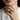 Curling Wave Ring, worn on model's hand resting on chin