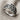 Embracing Wings Ring, angled front view on textured fabric