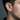 Side profile of male model wearing thick geometric brushed silver hoop earring with precise hinge closure