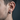 Side profile view of a man wearing the chunky geometric hexagon hoop earring showcasing its brutalist design.