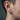 Thick brutalist weathered hoop earring worn by a male model showcasing the 15mm scale and rugged oxidized texture.