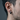 Side view of chunky faceted geometric hoop earring worn by a model showcasing its brutalist matte silver finish