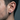 Close-up of brutalist sterling silver hoop earring being worn by a male model showcasing size and fit