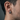 Close-up of men's chevron hoop earring worn on ear showcasing the matte brushed finish and intricate braided detail