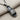 Detailed angled view of handcrafted slide sandal pendant highlighting the textured footbed and dark silver finish