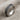 Close-up of the oxidized silver Celtic knot ring resting on a textured beige fabric highlighting band details