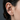Side profile of a model wearing the oxidized silver arrow ear cuff securely attached to the ear cartilage